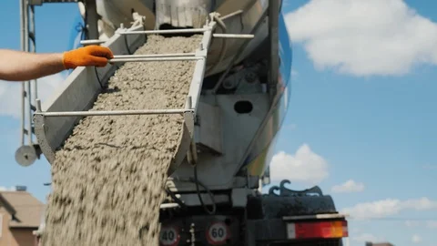 Work on pouring the foundation, the worker directs the chute from which the Stock Footage 92862842