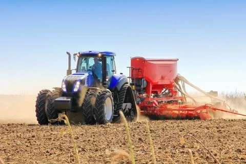 Work of a powerful tractor in field cultivation and cultivation. Stock Photos