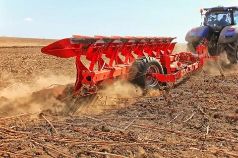 Work of a powerful tractor in field cultivation and cultivation. Agronomy Stock Photos