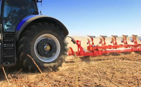 Work of a powerful tractor in field cultivation and cultivation. Stock Photos