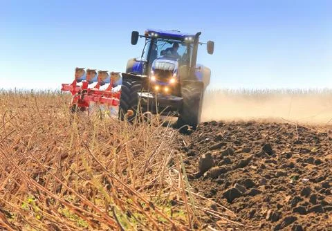 Work of a powerful tractor in field cultivation and cultivation. Stock Photos