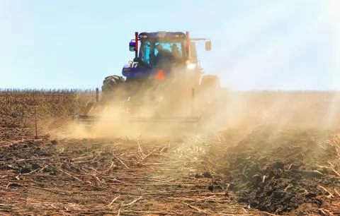 Work of a powerful tractor in field cultivation and cultivation. Agronomy, Stock Photos