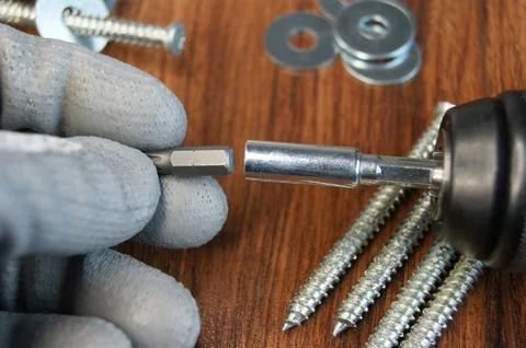 Work process of the builder. Inserting a Torx Bit into the Bit Adapter Stock Photos