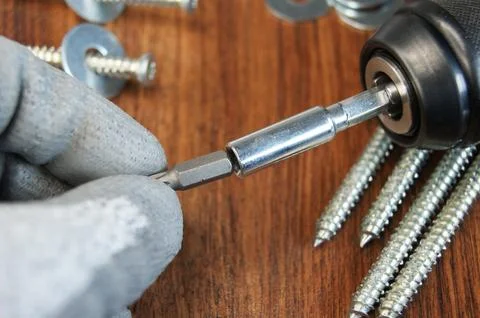 Work process of the builder. Inserting a torx Bit into the bit adapter Stock Photos