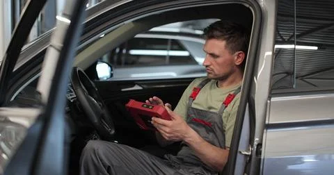 Work Process in the maintenance center. Mechanic is using modern technologi.. Stock Photos