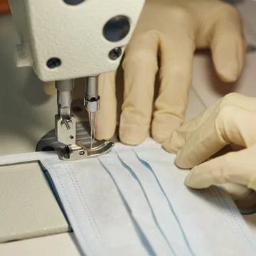 Work process of sewing masks for protection against coronavirus Stock Photos