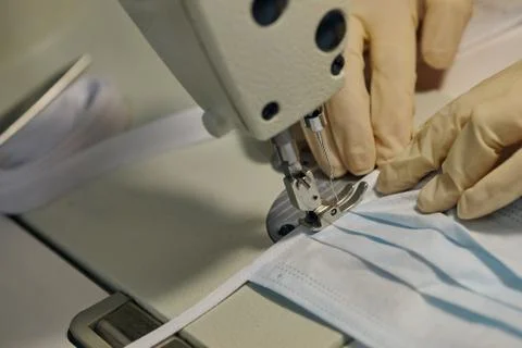 Work process of sewing masks for protection against coronavirus Stock Photos