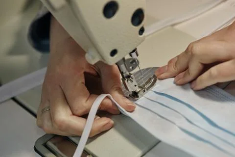 Work process of sewing masks for protection against coronavirus Stock Photos