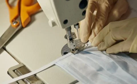 Work process of sewing masks for protection against coronavirus Stock Photos