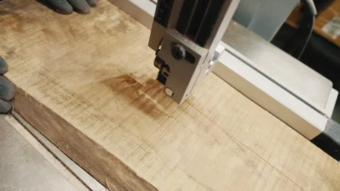 A work process on a woodworking machine where a wooden board is being processed Stock Footage 277402138