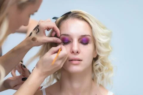 The work of a professional make-up artist, beautician, makes makeup on the fa Stock Photos