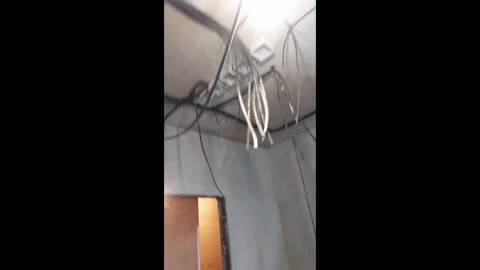 Work in progress on ceiling wiring and lighting installation in a building Stock Footage 327180777
