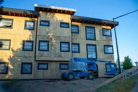 Work in progress construction site on a new building with a crane. Morning. Stock-Fotos