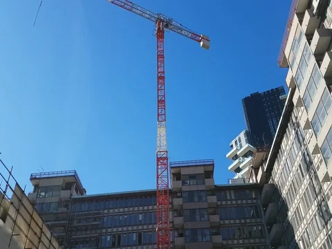 Work in progress for the construction of some buildings. View of a crane Stock-Footage 73115541