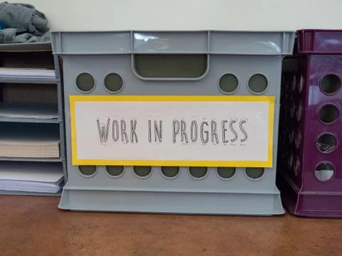 "Work in progress" handwritten  sign on storage bin Stock Photos