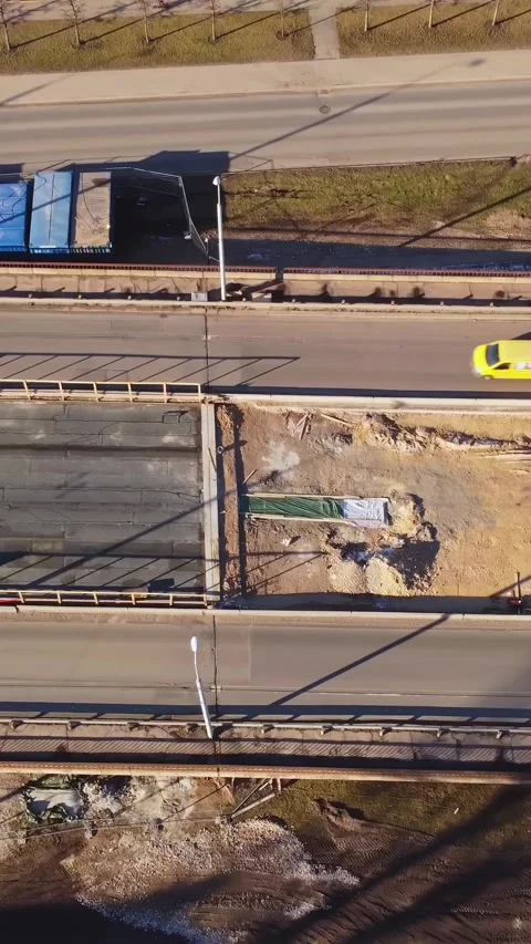 Work in progress on a road construction site. Vertical top down aerial drone Stock Footage 309113317