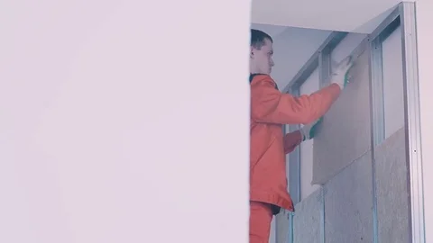 Work pushes the insulator in the wall Stock Footage 77350141