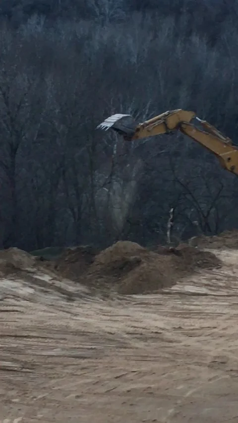 Work in a quarry, a crane breaks trees Stock Footage 171684093