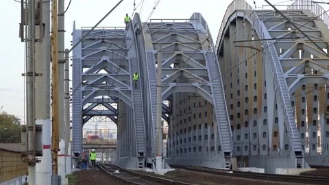 Work on the railway. High-rise workers treat the old railway bridge with prot Stock Footage 161128564