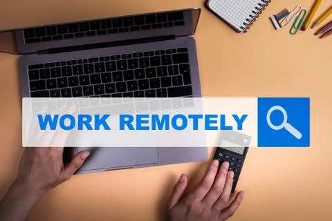 WORK REMOTELY. Work with computer from home. Calculator and stationery Stock Photos