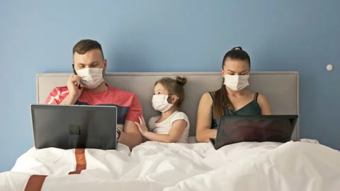 Work remotely. Young couple forced to work at home due to quarantine. On the Stock Footage 128518052
