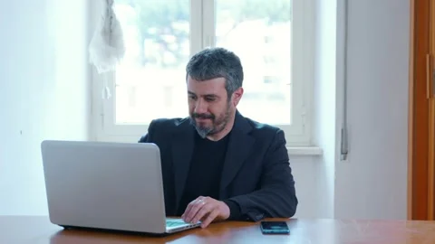 Work remotly - worker in video call on computer wearing jacket over boxers 스톡 동영상 149513312