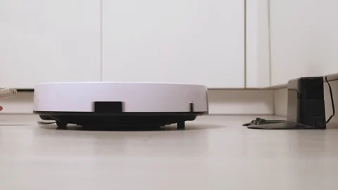 The work of a robot vacuum cleaner. Modern technologies Stock-Footage 127803894