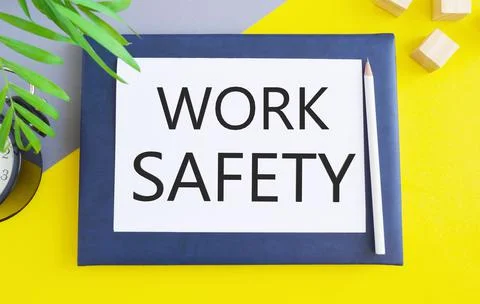 Work Safety message text written on white paper above Notebook.Conceptual pho Stock Photos