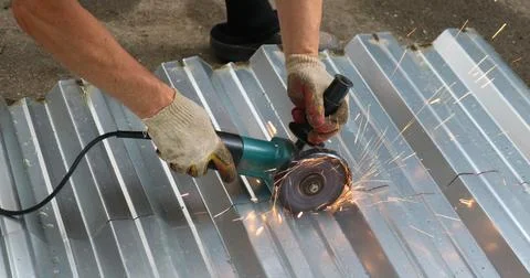 Work on sawing iron with a grinder Stock Photos