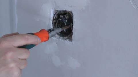 Work with a screwdriver with an old electric switch Stock Photos