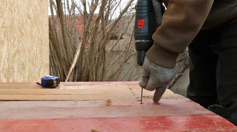 Work with a screwdriver when fixing boards Stock Photos