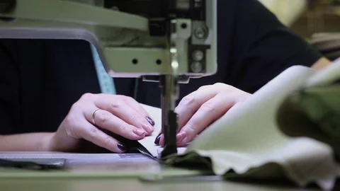 WORK ON A SEWING MACHINE, MANUFACTURING LEATHER GOODS Stock Footage 94100338