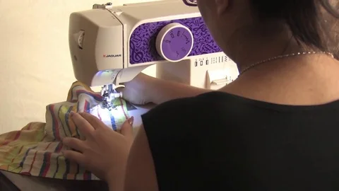 Work on the sewing machine, the seamstress sews a line, plan from the back Stock Footage 81088330