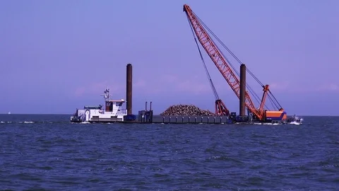 Work ship with basalt blocks for dyke improvement. Stock Footage 118669751
