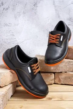 Work shoes leaning on old bricks Foto stock