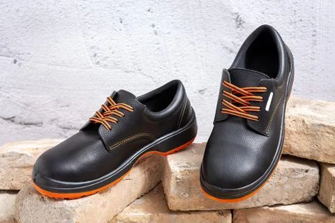 Work shoes on old bricks Stock Photos