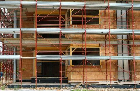 Work site for the construction of a new brick building, covered with scaffo.. 写真素材
