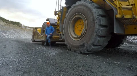 Work is sitting at the bottom of a large bulldozer fun talking. Video stock 55772639