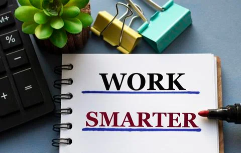 WORK SMARTER - words is written in a notebook with a marker, calculator, clam Stock Photos