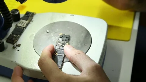 Work a soldering iron on PCB of mobile Stock Footage 73616134