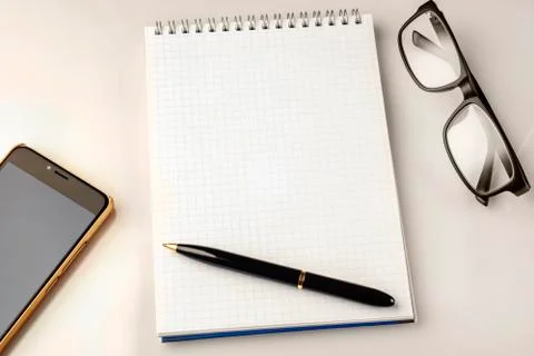 Work space accessories: pen, notebook, glasses and a modern smartphone 스톡 사진