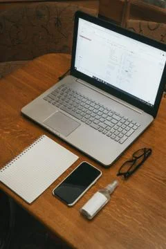 Work space with hands, laptop, notebook, glasses, pen, phone iPhone X Stock Photos