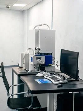 Work space of a scientist with Electron microscope, table and computer Stock Photos