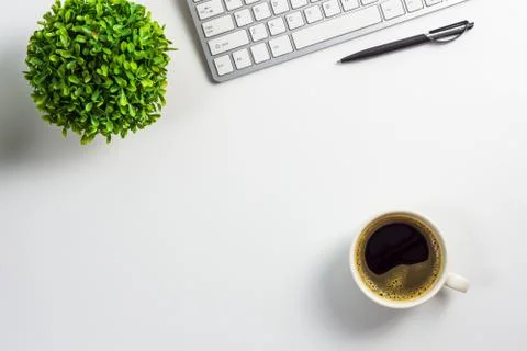 Work space on table with computer keyboard, pen, coffee cup and plant pot, to Stock Photos