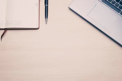 Work space table with a laptop and an agenda. Stock Photos