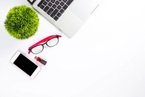 Work space on table with laptop computer, glasses, smart phone, flash drive a Stock Photos