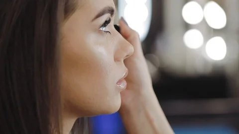 The work of a stylist with the face of a model in a beauty salon studio Stock Footage 104647889