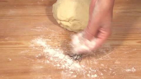 The work surface being dusted with flour for the dough to be kneaded Stock Footage 24673410