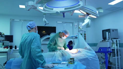 Work of surgeons in operating room. Doctors in medical uniform Stock Footage 158367634