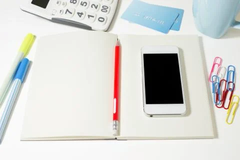 Work table with blank notebook, phone, calculator, credit card and pencil Stock Photos